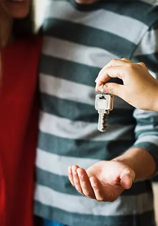 couple receiving key to property